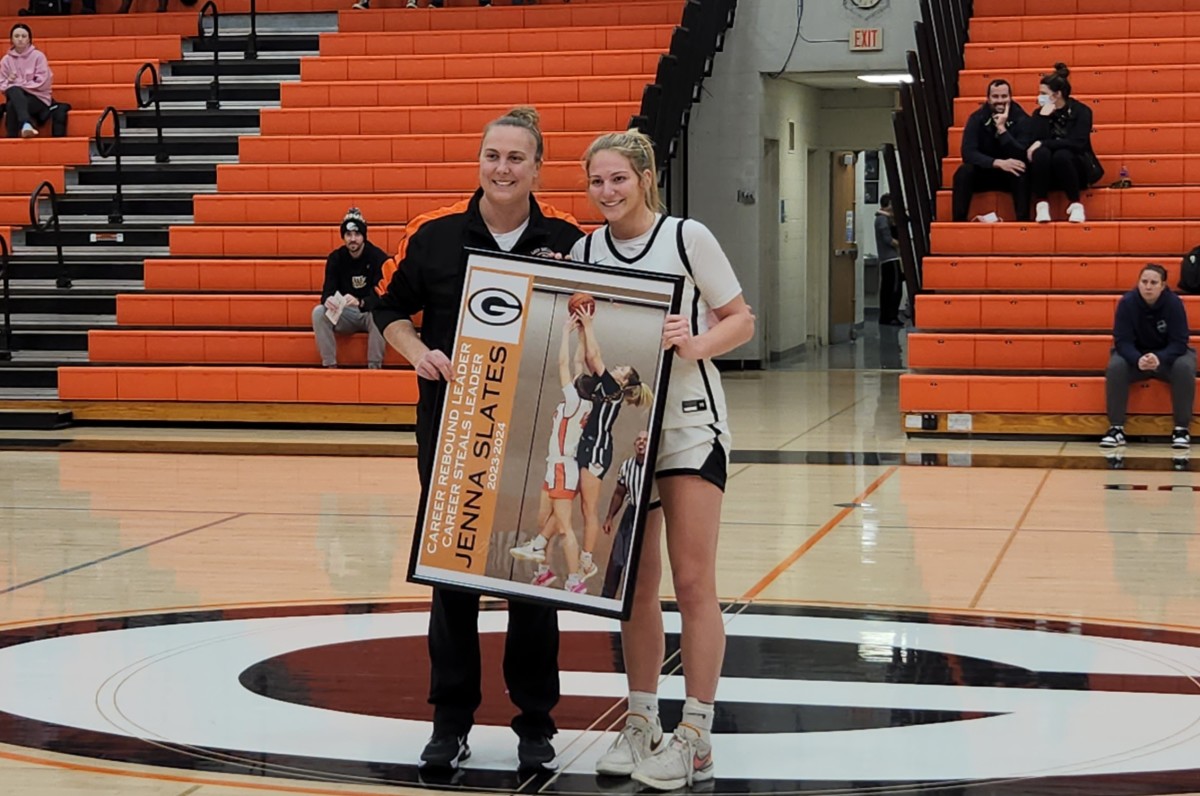 Green Junior Jenna Slates poses with head coach Alicia Manning after breaking the Green girls basketball career rebounding record in a game against Solon on Monday, January 8, 2024. Photo credit: Ryan Isley, SBLive Sports